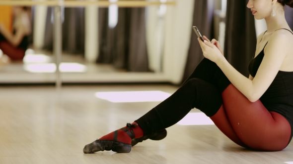 Beautiful Girl Wearing Ballet Leotard With Cellphone alt