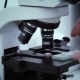 Man&#39;s Hand Laboratory Scientist Set Glass Slide In The Microscope For Analysis. - VideoHive Item for Sale