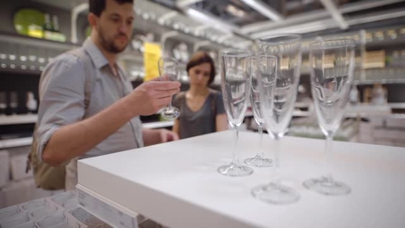 A Newly Married Couple Choosing Glasses alt