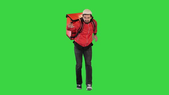 Courier is Delivering Food in Difficult Weather Conditions on a Green Screen Chroma Key alt
