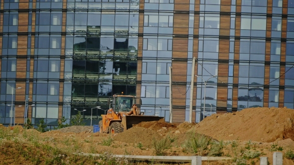 A New City Is Built: Grader Machines Working At Construction Site alt