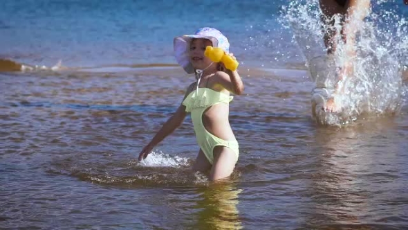 Cute Little Blonde Girl Having Fun By a Lake alt