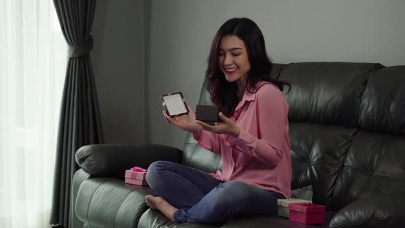 young woman open gift box in living room