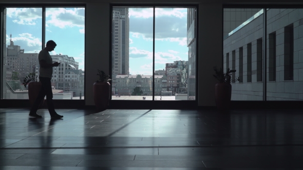 The Young Man Goes Down a Long Corridor Room With High Windows In Which Dark And Gaining a Message alt