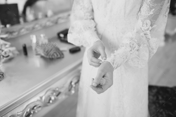 Black and white wedding picture of a bride getting ready.