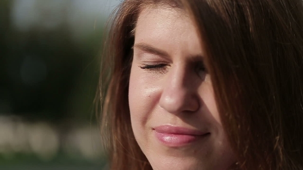 Beautiful Woman Straightens Her Hair With His Hand.