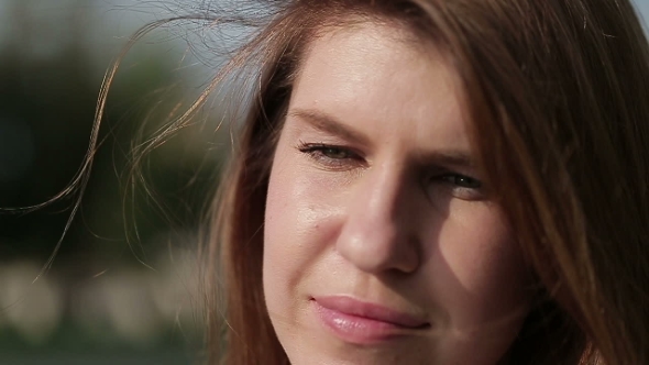Young Girl Straightens Her Hair With His Hand. 