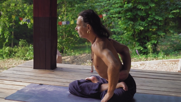 Man Performs His Exercise Twisting. alt