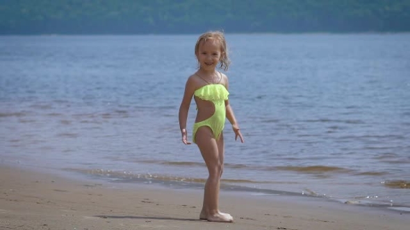 Cute Little Blonde Girl Having Fun By a Lake alt