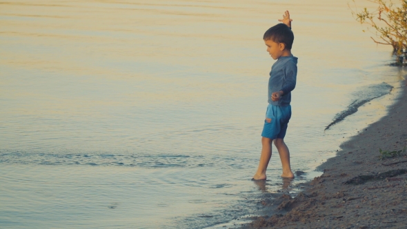 A Boy Playing Near the Water