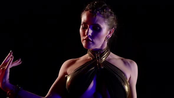 A Closeup Woman Who is Dancing an Oriental Belly Dance in the Studio Makes Beautiful Movements with alt