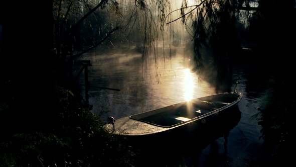Moored Row Boat in a Misty River at Sunset – Serene Scene alt