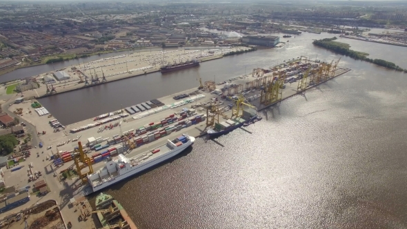 Aerial view of a seaport with cranes, ships, containers and cargo in Saint-Petersburg, Russia alt