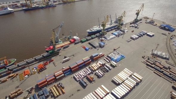 Aerial view of a seaport with cranes, ships, containers and cargo in Saint-Petersburg, Russia