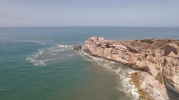 Lighthouse on Sao Miguel Arcanjo fort, Portugal. Aerial forward alt