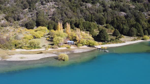 Top aerial panoramic landscape photography. Beautiful farm near a cristal clear lake water. View of alt