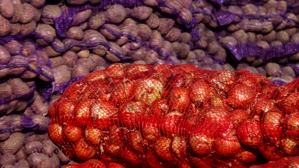 Sacks of potatoes and onions. Stock of vegetables.