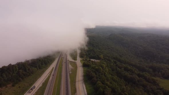 Aerial View Of Foggy Rarity Mountain Rd In Tennessee, USA - Drone Pullback Shot alt