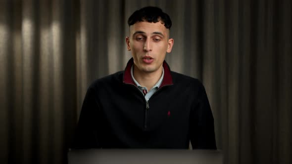 Male office worker communicates in zoom with work colleagues or clients alt