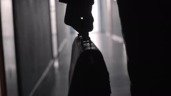 Hand of Businessman Carrying Briefcase along Hallway