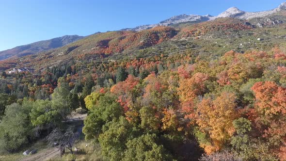 A drone flies over the rocks and slopes of  Dry Creek Trailhead in Alpine, Utah as leaves change int alt
