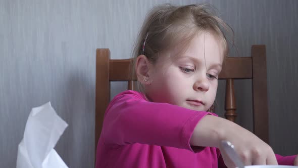 Child Girl Wipes His Mouth With White Towel After Eating