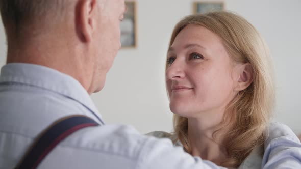 Married Couple Smiling Woman Lovingly Looks at Her Husband and Hugs Him Tightly Closeup