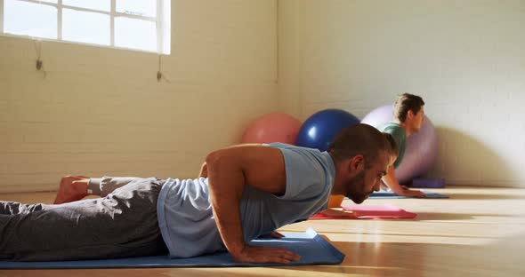 Group of people doing yoga  alt