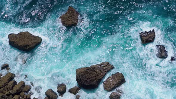 Top View of the Ocean Shore with Waves Crashing on Rocks alt