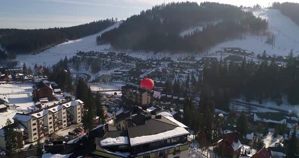 Aerial View Of Village In Valley Between Mountains alt