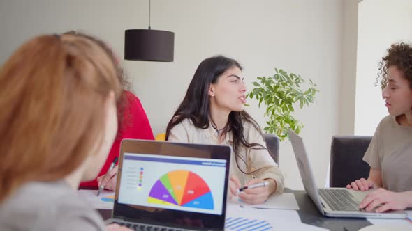 Motivated Middle Aged Asian Female Team Leader Explaining Company Development Strategy to Smiling alt