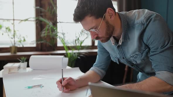 Architect Working on Blueprint with Spesial Tools and Pencil, Close Up. Male Architect at Work, Only alt
