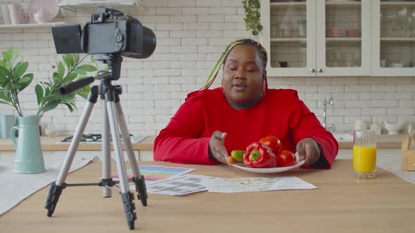 Black Female Food Blogger Recording Vlog in Kitchen alt