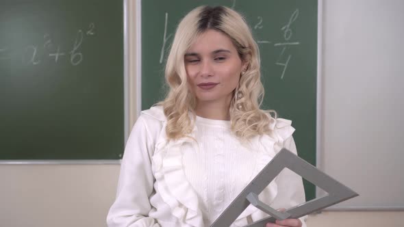 Portrait of a Mathematics Teacher on the Background of a School Board alt