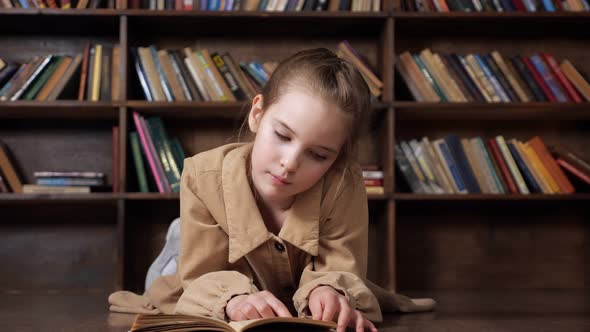 Concentrated Young Lady Reads Book Preparing for Lesson alt