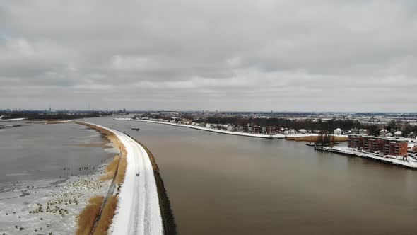 Frosted Crezeepolder And River Noord With Cargo Ship Sailing Near Ridderkerk In Netherlands. - Stati alt