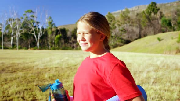 Girl drinking water in the boot camp on a sunny day 4k