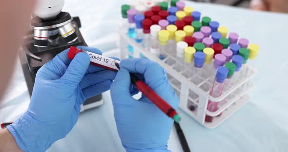 Doctor Holding Test Tube with Covid Test and Ticking Positive Box  Movie alt