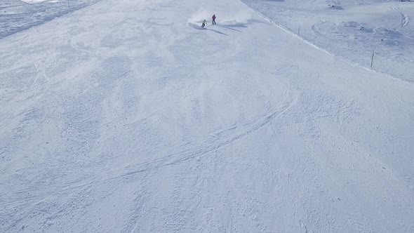 Slow motion aerial shot of two downhill skiers, South Tyrol, Italy
