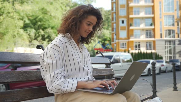 Young Hispanic Girl Working on a Laptop Outdoors After Quarantine alt