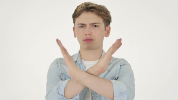 Young Man Showing No Sign By Arm Gesture on White Background alt