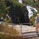 Woman Taking Pictures at the Majestic Waterfall of Woringsfossen in Norway - VideoHive Item for Sale
