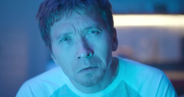 Close Up of Man Watching Action Movie on Tv in Evening at Home alt