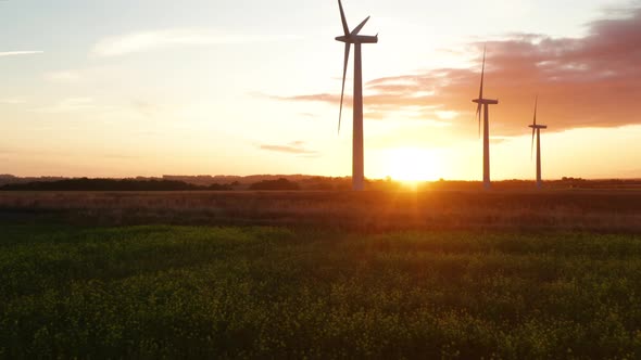 There wind turbines at sunrise