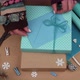 Woman packing Christmas gifts with blue paper - VideoHive Item for Sale