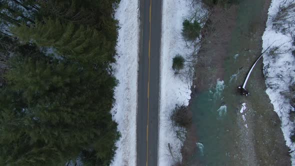 Aerial View From Above of Road By Fresh Water Flowing Down a River Creek alt