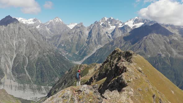 Woman with Backpack Hiking on Mountain Ridge in Caucasus Mountains Georgia alt