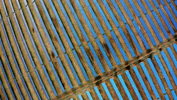 Aerial Top Down View of Solar Sower Station. Flying above Solar Farm with Sunlight. alt
