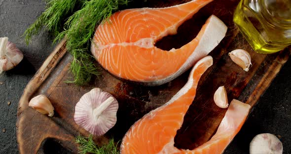 Raw Salmon Steaks with Garlic and Dill Slowly Rotate. 