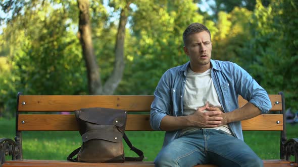 Man Relaxing on Bench, Suddenly Feeling Strong Stomach Ache, Gastritis Problem alt